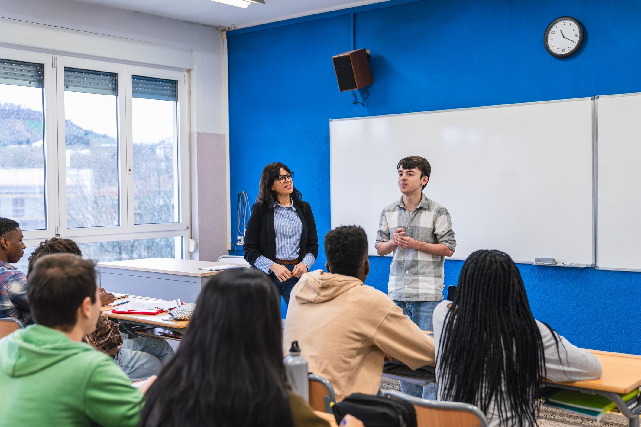 Student speaking in front of classroom