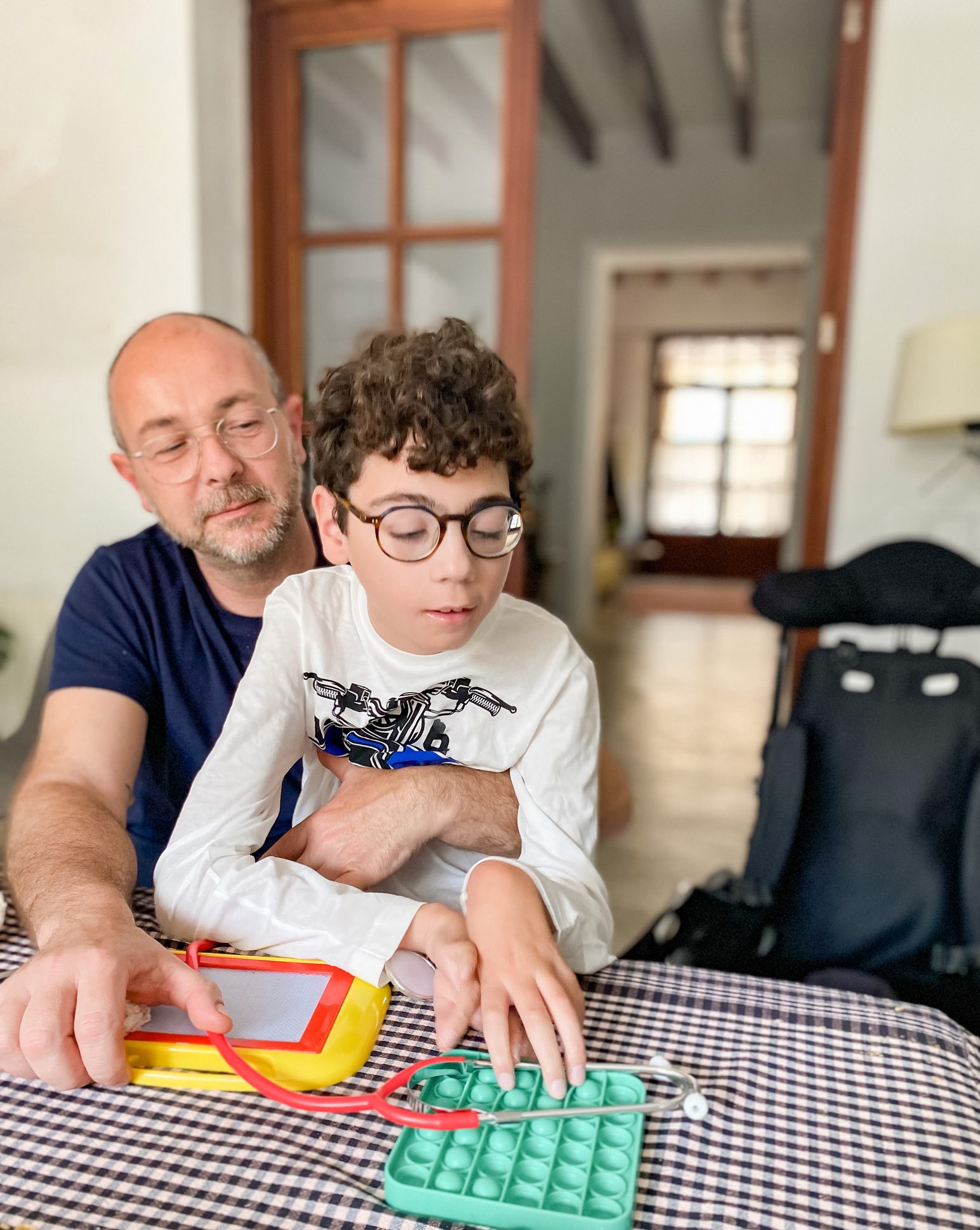 Father and son playing at table